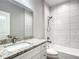 Clean bathroom with granite counters, white cabinets and tiled shower at 501 Mulberry St, Fruitland Park, FL 34731