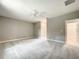 Neutral bedroom with ceiling fan and walk-in closet entrance at 501 Mulberry St, Fruitland Park, FL 34731