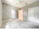 This bedroom features plush carpeting, a ceiling fan, and a closet for ample storage at 501 Mulberry St, Fruitland Park, FL 34731