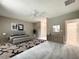 Neutral bedroom featuring a plush bed, ceiling fan, and modern dresser at 501 Mulberry St, Fruitland Park, FL 34731
