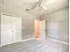 Empty bedroom featuring a ceiling fan and closet with bifold doors at 501 Mulberry St, Fruitland Park, FL 34731