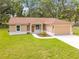 Charming single-story home with beautiful landscaping and a two-car garage at 501 Mulberry St, Fruitland Park, FL 34731