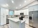 Bright kitchen showcasing stainless steel appliances, granite countertops, and abundant storage in white cabinets at 501 Mulberry St, Fruitland Park, FL 34731