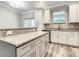 Bright kitchen with granite countertops, stainless steel appliances, and stylish gray cabinets, perfect for cooking at 501 Mulberry St, Fruitland Park, FL 34731