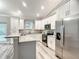 Modern kitchen featuring stainless steel appliances, granite countertops, and ample white cabinetry for storage at 501 Mulberry St, Fruitland Park, FL 34731