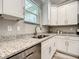 A well-appointed kitchen features stainless steel appliances, granite countertops, and abundant cabinet storage at 501 Mulberry St, Fruitland Park, FL 34731
