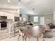 Open-concept living space with a seamless connection to the kitchen and dining area, filled with natural light at 501 Mulberry St, Fruitland Park, FL 34731