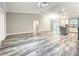 Bright open-concept living space with vaulted ceilings, gray floors, and modern kitchen at 501 Mulberry St, Fruitland Park, FL 34731