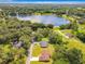 Aerial view of a house near a serene lake, surrounded by lush greenery, highlighting the property's scenic location at 509 Mulberry St, Fruitland Park, FL 34731