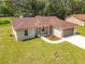 Aerial view of a single-story home, two-car garage, long driveway, landscaped yard, and green lawn at 509 Mulberry St, Fruitland Park, FL 34731