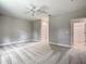 A bedroom that features neutral walls, a ceiling fan, a closet, and access to an ensuite bathroom at 509 Mulberry St, Fruitland Park, FL 34731