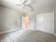A bedroom that features neutral walls, a ceiling fan, a closet, and access to an ensuite bathroom at 509 Mulberry St, Fruitland Park, FL 34731