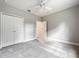 Neutral bedroom featuring a ceiling fan, plush carpet, and a double-door closet at 509 Mulberry St, Fruitland Park, FL 34731