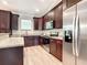 Updated kitchen features dark wood cabinets, stainless steel appliances, and granite countertops at 509 Mulberry St, Fruitland Park, FL 34731