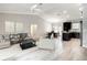 Bright, open-concept living space with modern light-colored floors and vaulted ceiling at 509 Mulberry St, Fruitland Park, FL 34731
