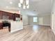 Open floor plan with modern kitchen with island and stainless steel appliances at 509 Mulberry St, Fruitland Park, FL 34731