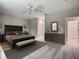 Spacious main bedroom featuring neutral walls, ceiling fan, a sitting area, and an ensuite bathroom at 509 Mulberry St, Fruitland Park, FL 34731