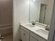 Bathroom featuring double sinks with quartz countertop, white cabinetry, and tile flooring and shower/tub at 618 Duke Dr, Haines City, FL 33844
