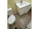 Bathroom with a toilet, and a vanity with white countertop and cabinets below at 6427 Breezewood St, Orlando, FL 32818
