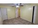 Cozy bedroom with tile flooring, ceiling fan, and natural light at 6427 Breezewood St, Orlando, FL 32818