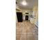 Well-equipped kitchen showcasing modern appliances, white cabinets, and tile flooring at 6427 Breezewood St, Orlando, FL 32818