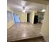 Bright living room with easy access to the kitchen with tile flooring at 6427 Breezewood St, Orlando, FL 32818