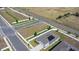 Areal view of home with solar panels and white perimeter fence, near a landscaped median at 660 Silver Palm Dr, Haines City, FL 33844