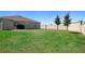 Large, green backyard with a privacy fence and well-maintained lawn at 660 Silver Palm Dr, Haines City, FL 33844