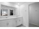 Bathroom with double sink vanity and a large mirror, plus entry to walk-in closet at 660 Silver Palm Dr, Haines City, FL 33844
