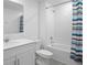 Bathroom featuring modern vanity, toilet and tub shower combo with colorful curtain at 660 Silver Palm Dr, Haines City, FL 33844
