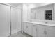 Bathroom features double sink vanity with modern fixtures, a shower and walk-in closet at 660 Silver Palm Dr, Haines City, FL 33844