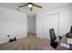 Spacious bedroom with plush carpeting, closet, and a ceiling fan at 660 Silver Palm Dr, Haines City, FL 33844