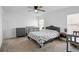 A spacious bedroom features neutral carpeting, ceiling fan, crib, dresser and windows for natural light at 660 Silver Palm Dr, Haines City, FL 33844