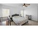 Bright bedroom with a ceiling fan, two windows, a crib, and a changing table at 660 Silver Palm Dr, Haines City, FL 33844