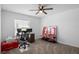 Bright bedroom features carpet, ceiling fan, window, desk and Liverpool decor at 660 Silver Palm Dr, Haines City, FL 33844