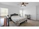Bright bedroom with a ceiling fan, two windows, a crib, and a changing table at 660 Silver Palm Dr, Haines City, FL 33844