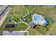 Aerial view of a community pool, playground, and dog park, with parking and walking trails at 660 Silver Palm Dr, Haines City, FL 33844