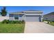 Charming single-story home with a gray exterior, a two-car garage, and a well-manicured lawn at 660 Silver Palm Dr, Haines City, FL 33844