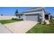 Inviting single-story home with a two-car garage, walkway to front door and a green lawn at 660 Silver Palm Dr, Haines City, FL 33844