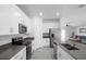 Bright kitchen with stainless steel appliances, white cabinets and a view into the living area at 660 Silver Palm Dr, Haines City, FL 33844