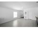 Bright open-concept living room with tile flooring and large windows, bathed in natural light at 660 Silver Palm Dr, Haines City, FL 33844