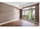 Cozy bedroom featuring natural light, wood-look tile flooring and a large window at 745 Riggs Cir, Davenport, FL 33897