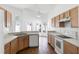 Bright kitchen features wooden floors, white countertops and modern appliances at 745 Riggs Cir, Davenport, FL 33897