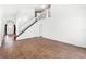 Open living area features wood-look tile, a staircase, and a view of the front door at 745 Riggs Cir, Davenport, FL 33897