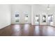 Bright living room with tile floors, arched windows, and access to the backyard at 745 Riggs Cir, Davenport, FL 33897