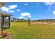 Spacious backyard with ample space for outdoor activities, enhanced by a screened lanai and lush green lawn at 7536 Sw 77Th Ave, Ocala, FL 34481