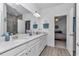Bright bathroom featuring double vanities, white cabinets, and a tile floor at 7536 Sw 77Th Ave, Ocala, FL 34481