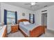 Comfortable bedroom features a wood bed frame, natural lighting, and ceiling fan at 7536 Sw 77Th Ave, Ocala, FL 34481