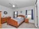 Cozy bedroom with a ceiling fan, wooden furniture, and blue accents at 7536 Sw 77Th Ave, Ocala, FL 34481