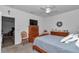 Inviting bedroom with wood furniture, neutral carpet, and view to living area at 7536 Sw 77Th Ave, Ocala, FL 34481